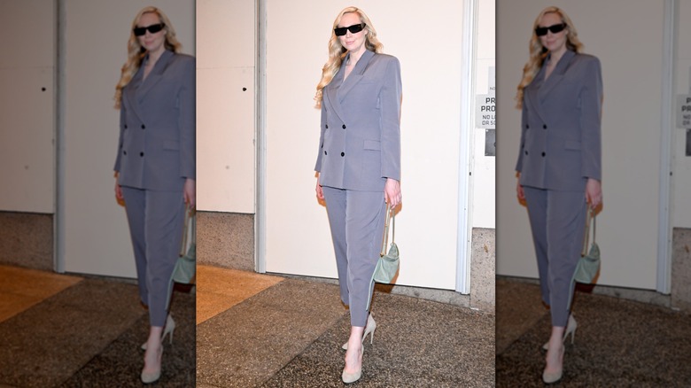 Gewndoline Christie photographed in New York City wearing a purple gray, double-breatsed suit and beige heels
