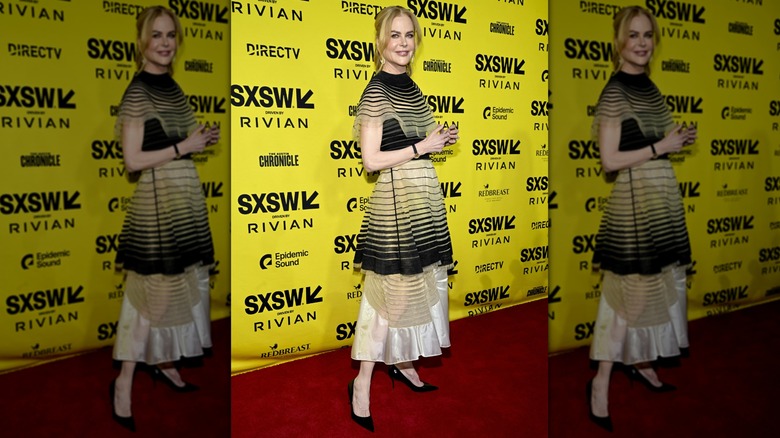 Nicole Kidman posing at a SXSW event while wearing a tiered dress and black, pointed-toed heels