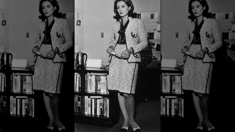 Barbara Walters, wearing a Chanel suit, standing in her office, New York City