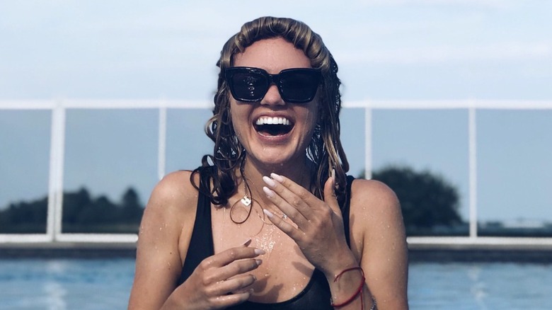 Erika Kirk with wet hair in a pool