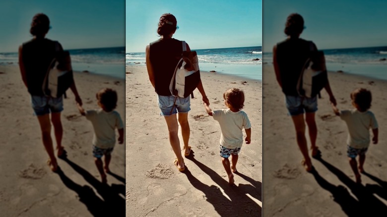 Joanna Gaines holding hands with her son on the beach