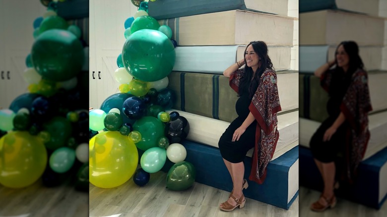 Joanna Gaines in a black dress and clog sandals