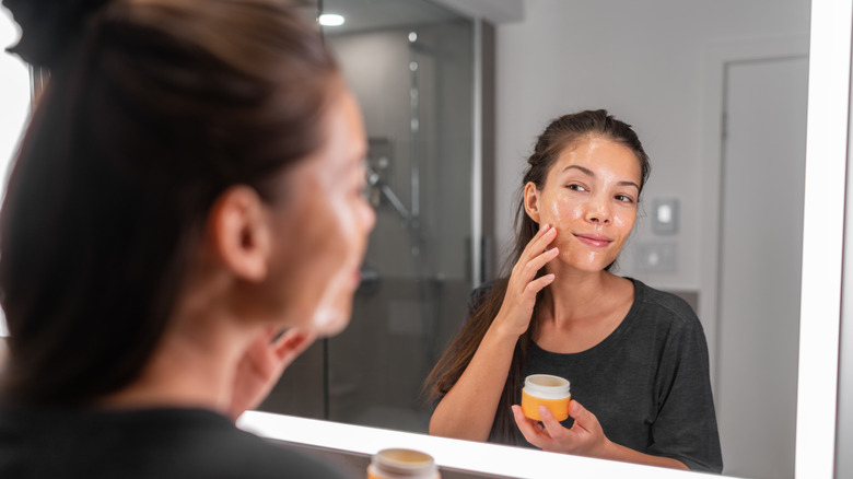Woman exfoliating face