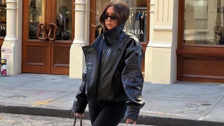 A woman in an oversized black jacket