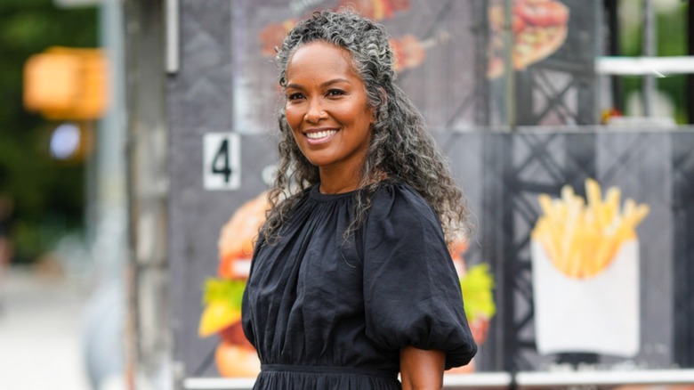 A woman with grey hair in defined curls