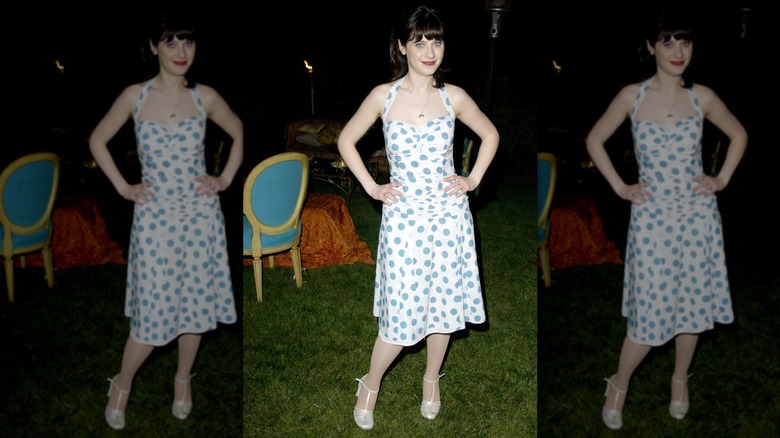 Zooey Deschanel posing with her hand on her hips while wearing a blue-and-white dress at a 2003 event