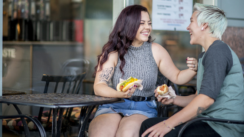 Women eating hotdogs