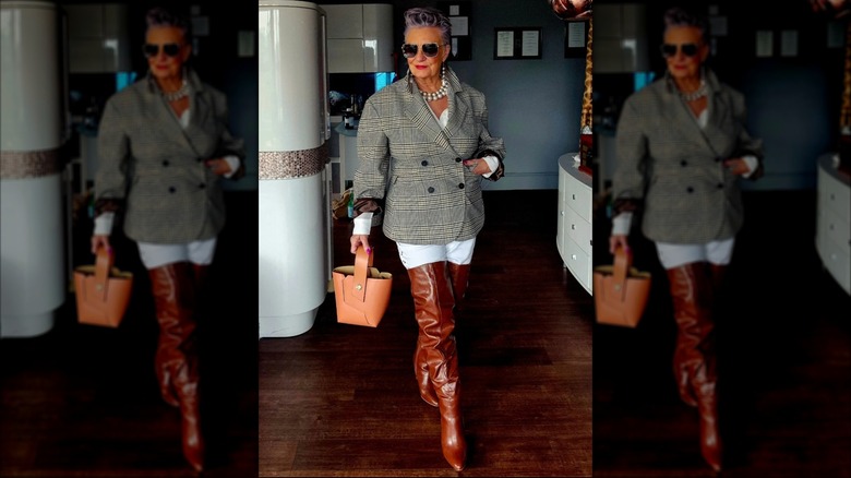 A woman wearing thigh-high brown boots