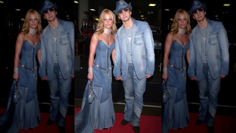 Britney Spears (R) and Justin Timberlake (L) hold hands wearing double denim outfits.