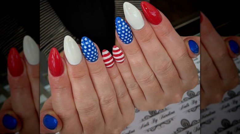 Two hands showing an American flag inspired manicure