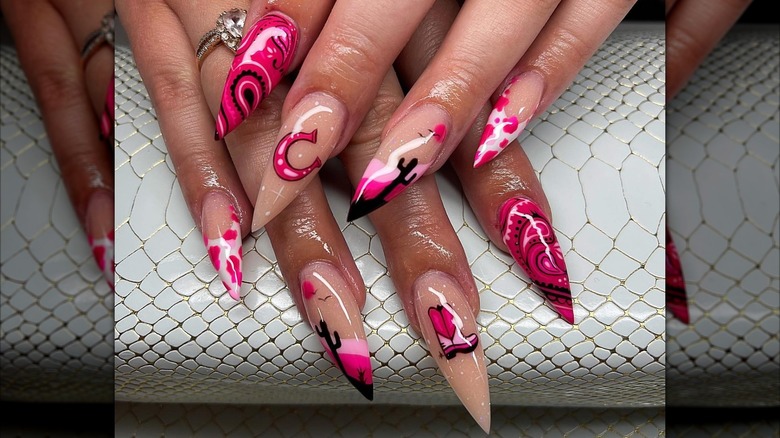 A woman with a long manicure with a pink wild west theme