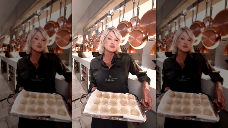 Martha Stewart posing with a tray of dumplings