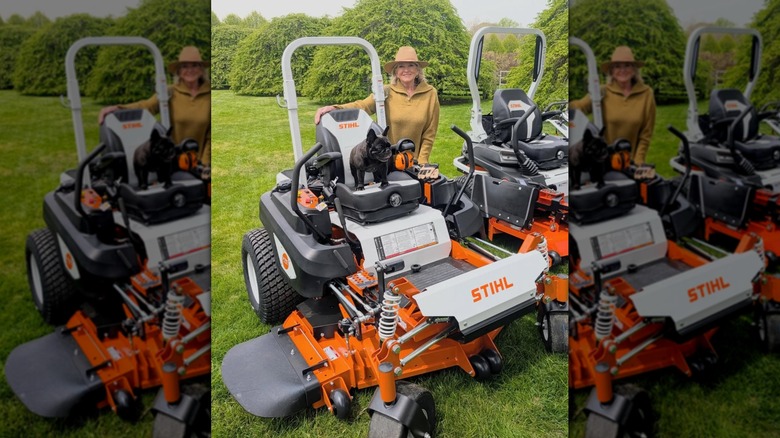 Martha Stewart posing with two orange STIHL mowers