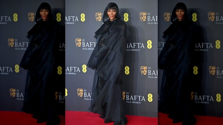 Naomi Campbell wearing a hooded cape at the BAFTAs