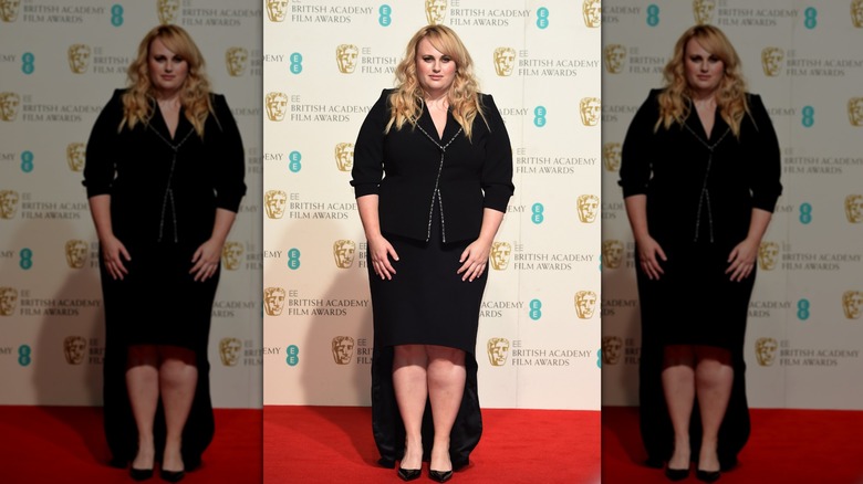 Rebel Wilson at the BAFTAs posing on the red carpet