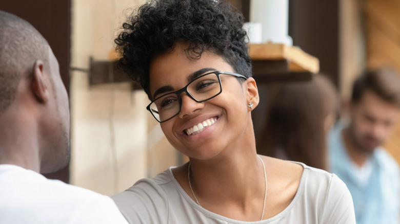 Woman smiling at a man 