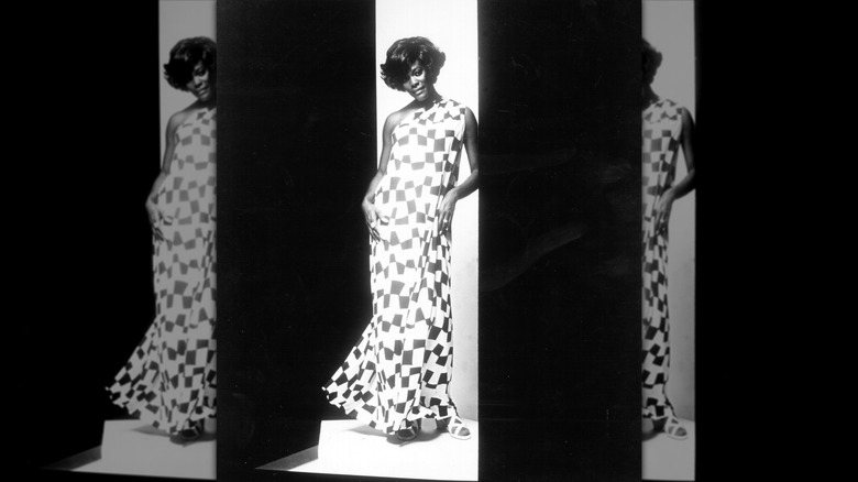 Dionne Warwick poses wearing a checkered dress