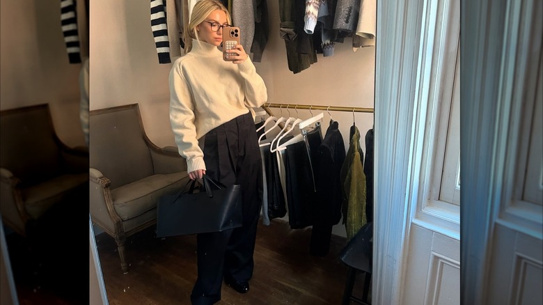 Woman in white turtleneck and black pants