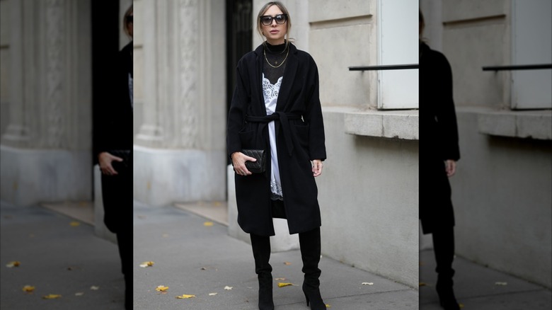 Woman wearing a slip dress over a turtleneck