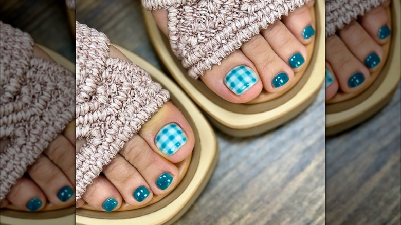 A woman with a blue picnic blanket inspired gingham pedicure