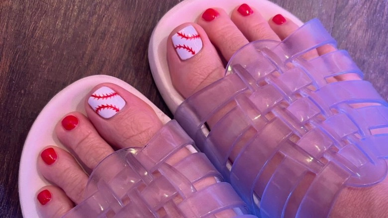 A woman's feet with a baseball inspired manicure
