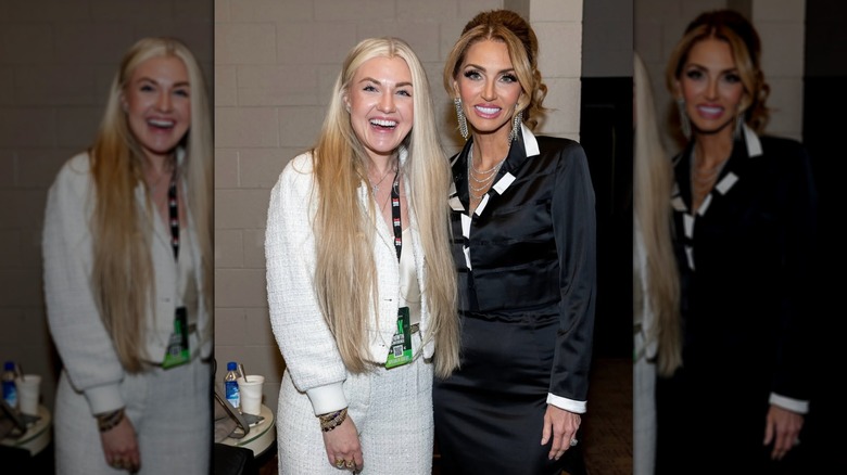 Erika Kirk in a white suit standing next to a woman in a black skirt suit