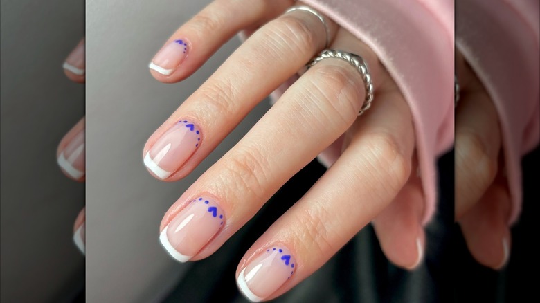 French manicure with blue hearts