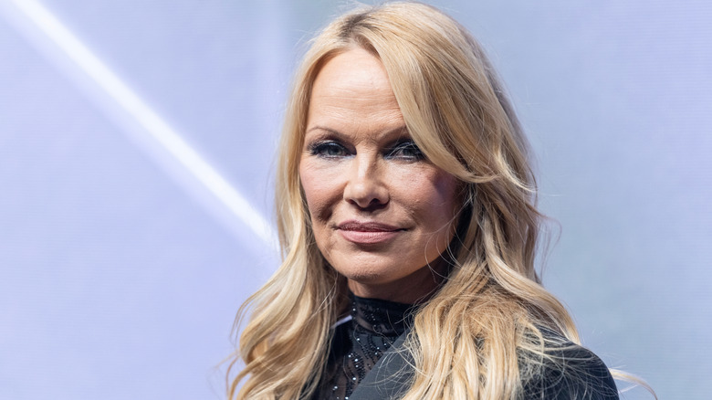 Pamela Anderson smiles on the red carpet in 2023