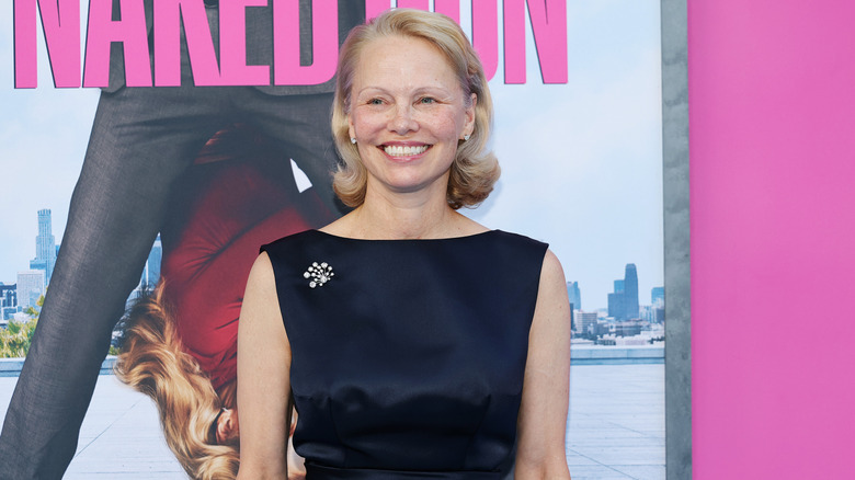 Pamela Anderson smiling on the red carpet in 2025