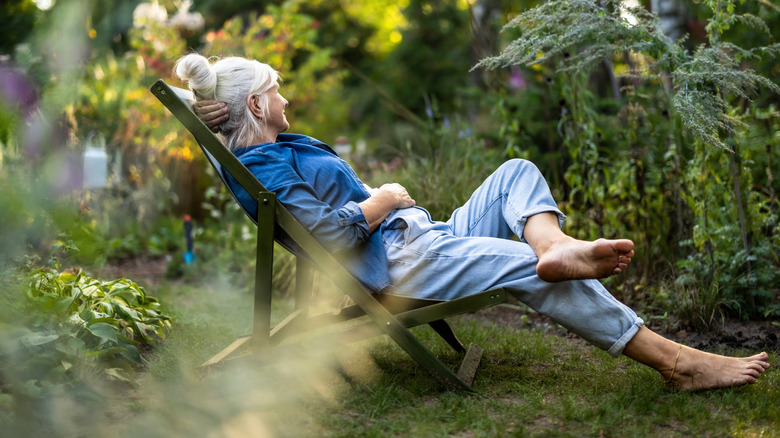 Older woman lounging in her garden