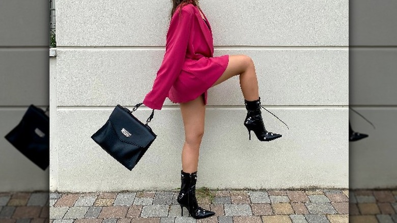 Woman holding top-handle bag
