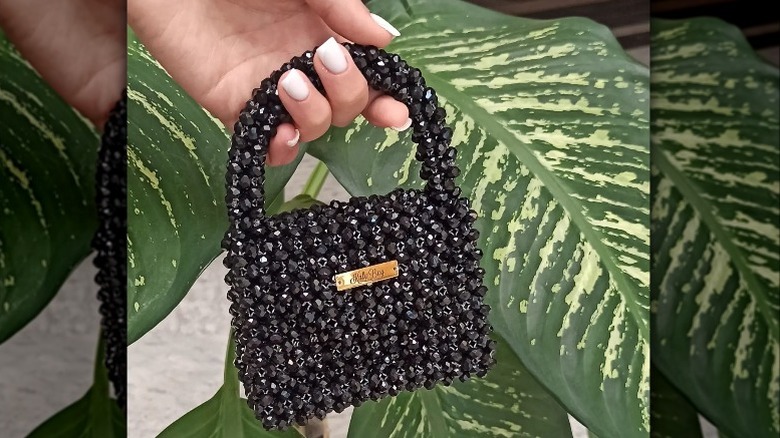 Woman holding top-handle bag