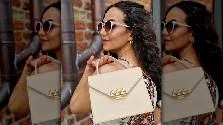 Woman holding top-handle bag
