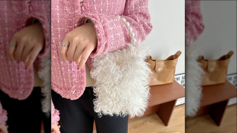 Woman holding top-handle bag