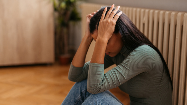 woman with head in hands