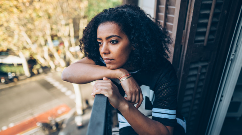 woman looking out from window