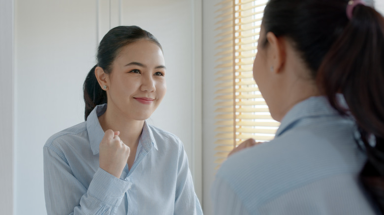 Woman smiling in mirror