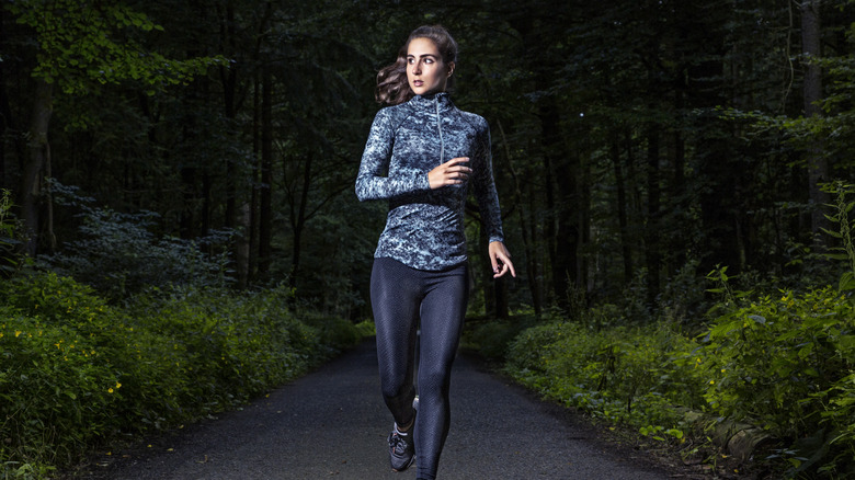 Woman running through the woods