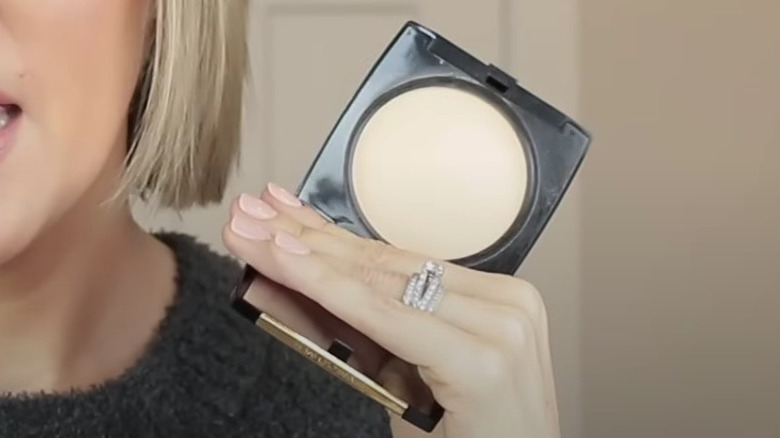 woman holding powder foundation