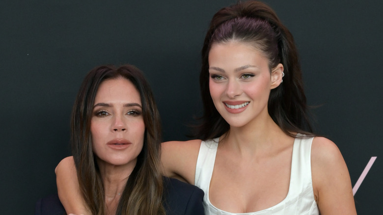Victoria Beckham and Nicola Peltz Beckham pose on the red carpet in 2024