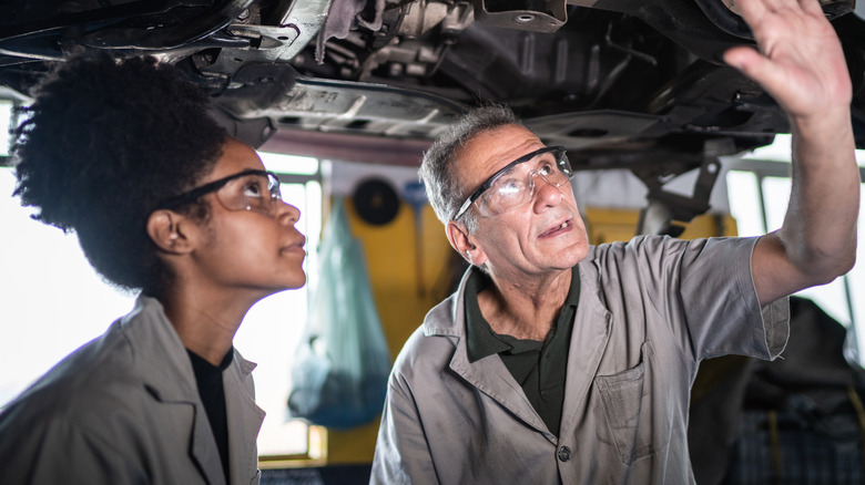 Two people working on a car