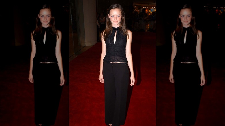 Alexis Bledel on the red carpet in a black blouse and black trousers