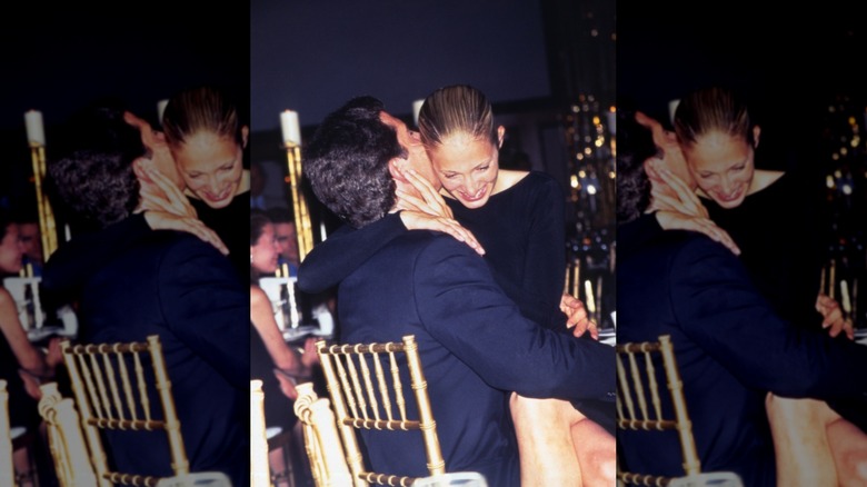 Carolyn Bessette Kennedy sitting on John F. Kennedy's lap, laughing