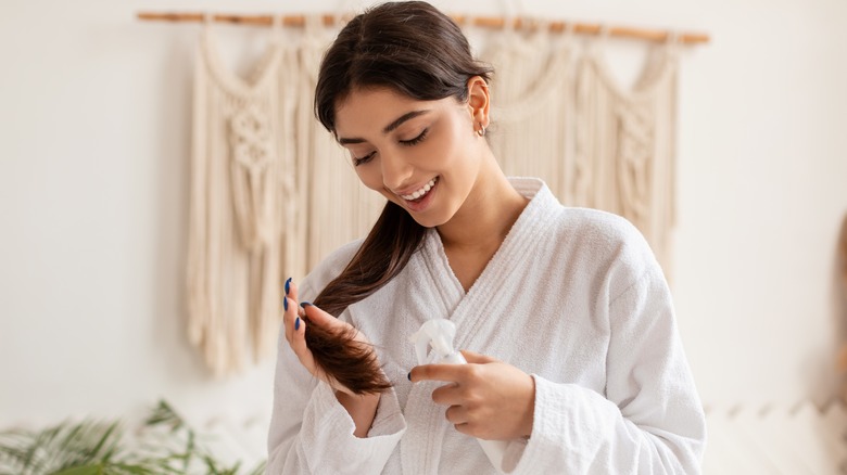 frustrated woman looking at hair in brush