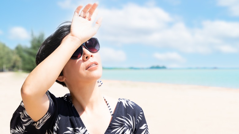 Woman shielding face from sun