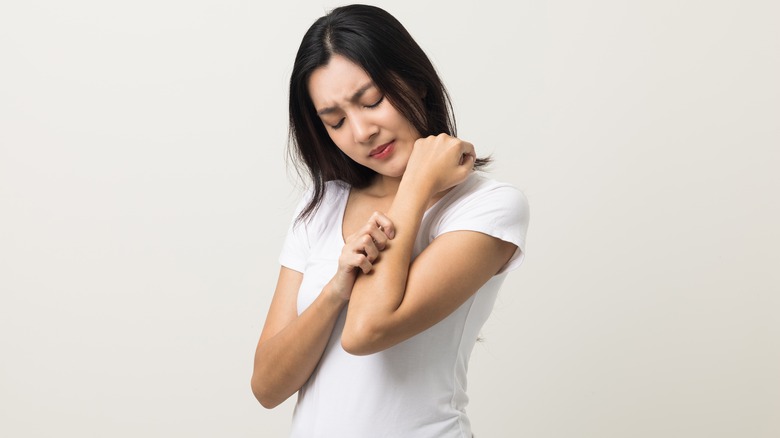 Woman scratching dry skin