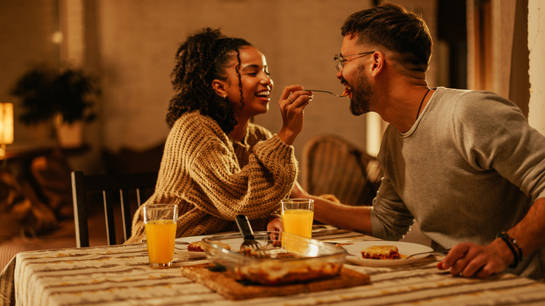 Couple feeding each other on date