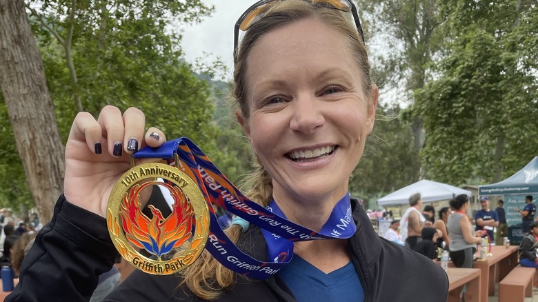 Jenna Busch running a marathon, with medal