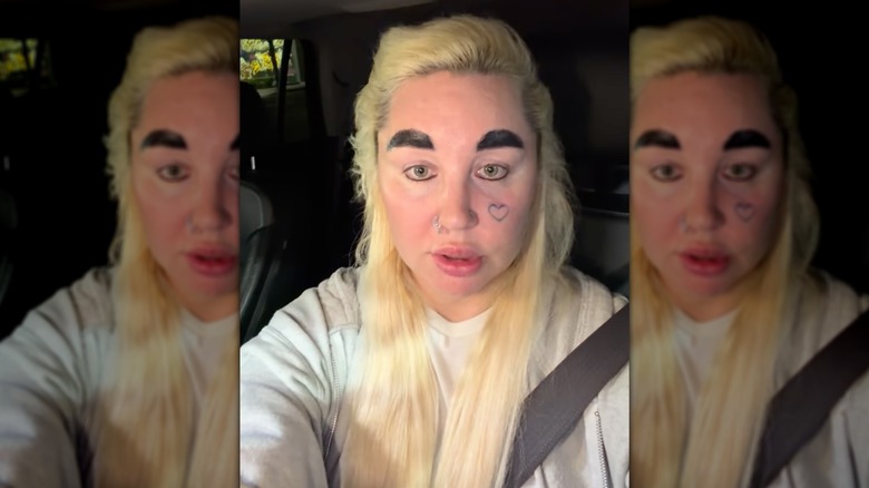 Amanda Bynes poses with thick dark eyebrows and blond hair