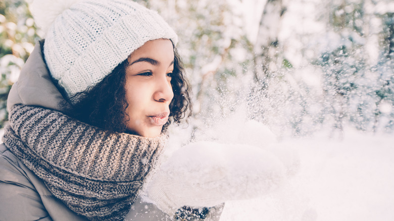 Woman blowing snow